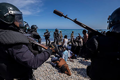 Weaponized migration image showing armed police and refugees