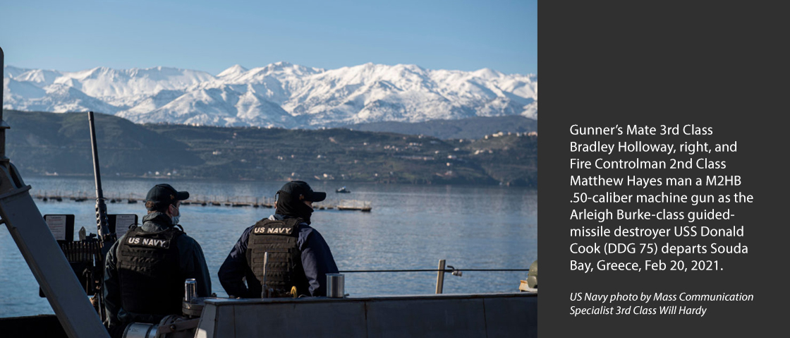 SOUDA BAY, Greece (Feb. 20, 2021) Gunner’s Mate 3rd Class Bradley Holloway, right, and Fire Controlman 2nd Class Matthew Hayes man a M2HB .50-caliber machine gun as the Arleigh Burke-class guided-missile destroyer USS Donald Cook (DDG 75) departs Souda Bay, Greece, Feb. 20, 2021.