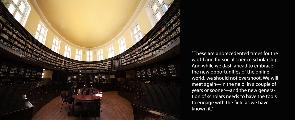 Female scholar studying along in library 