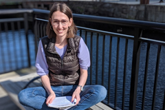 2018-19 J-WAFS Fellow Andrea Beck sits by the Charles River. 