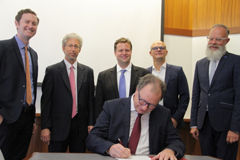 Standing, left to right: Justin Leahey, MIT-Germany program manager; David Dolev, MISTI assistant director; Markus Buehler, MIT-Germany faculty director, professor, and head of the Department of Civil and Environmental Engineering; Ulrich Steinbach, deputy minister of the Baden-Wuerttemberg Ministry of Science, Research, and the Arts; Wolfgang Holtkamp, senior advisor if international affairs at the University of Stuttgart. Seated: Wolfram Ressel, professor and rector of the University of Stuttgart. 