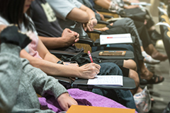 People in meeting with notepads